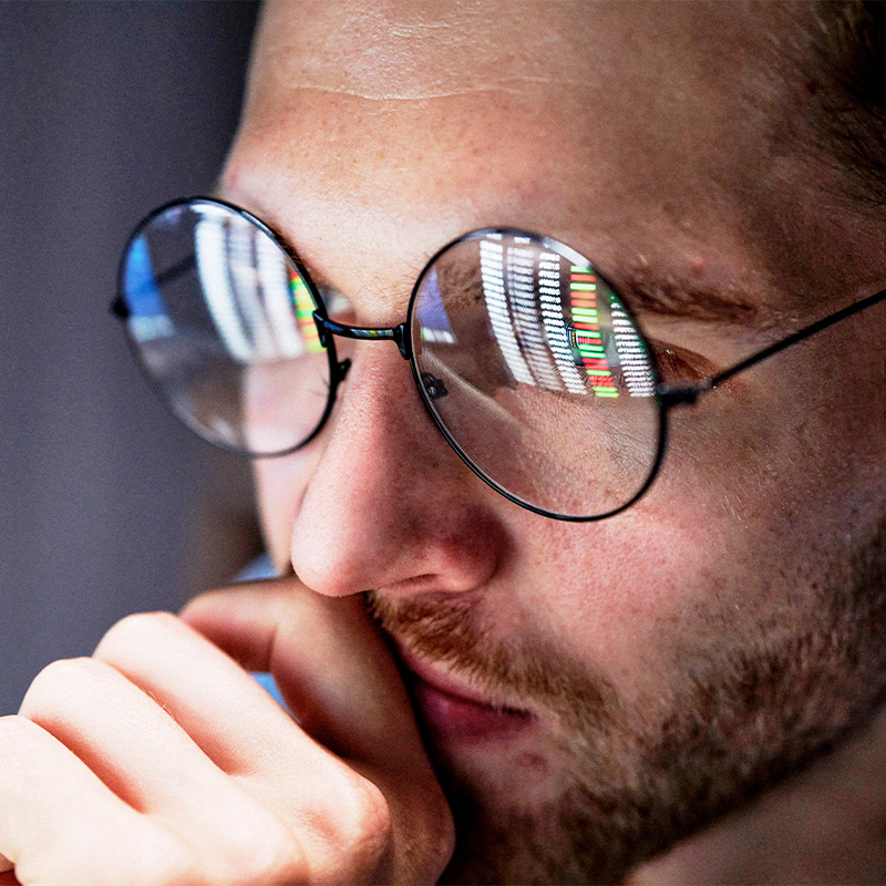 800x800 strillo box focus Close up of a man looking at a computer screen that is reflected
