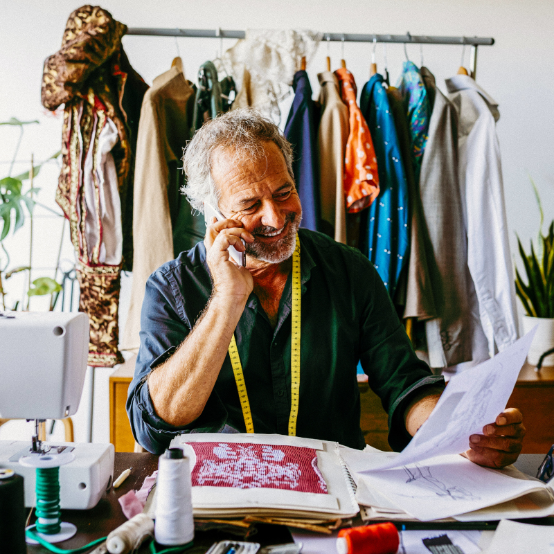 A male fashion designer is on the phone 800